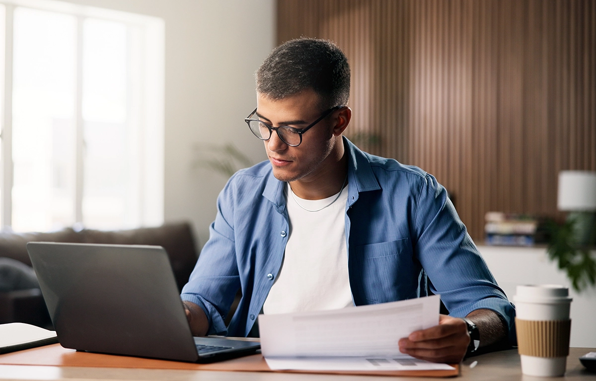 Person analysing bond investment research and financial documents on a laptop